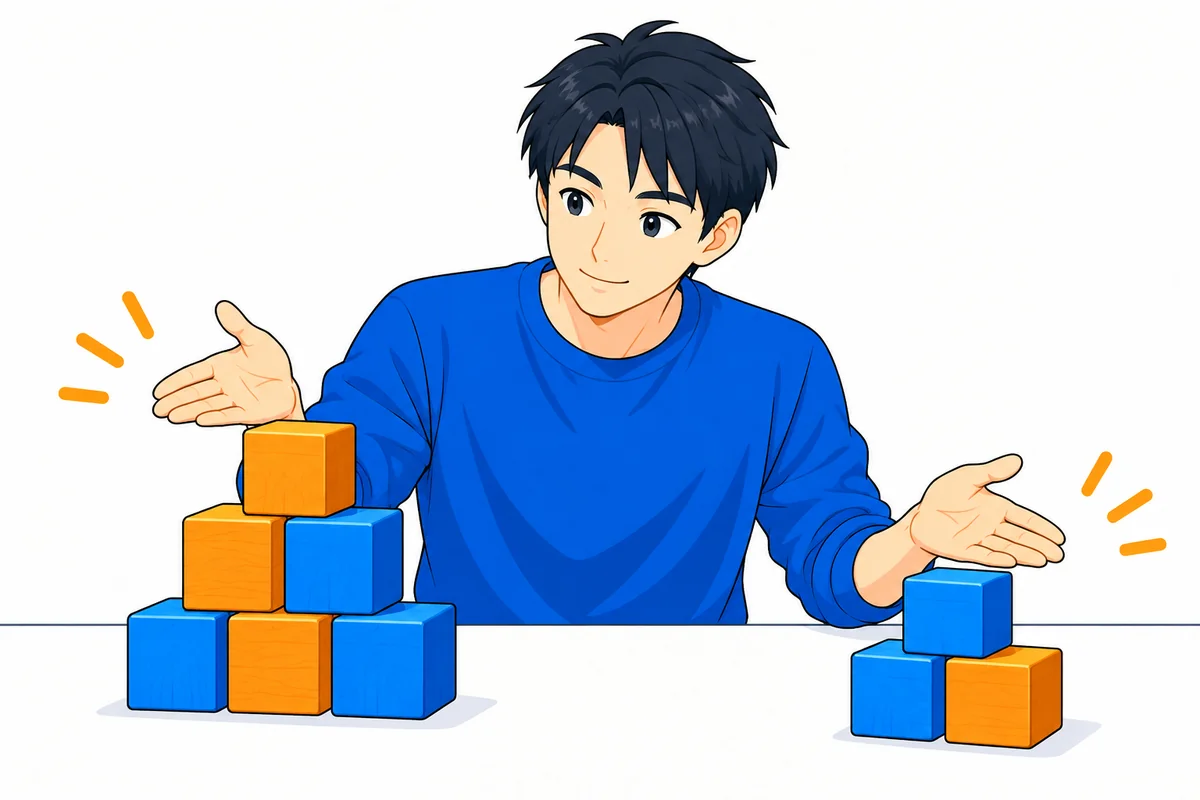 大小2つの積み木の量を見比べて考える男性